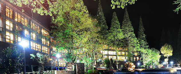 Forest hot-spring resort buildings illuminated at night